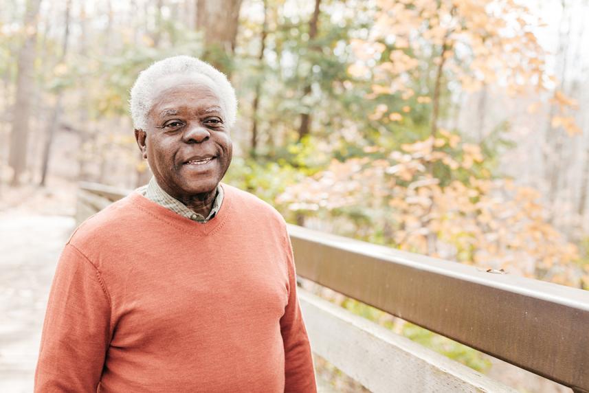 A man smiling in a park