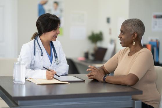 Doctor and patient talking while sitting at a table